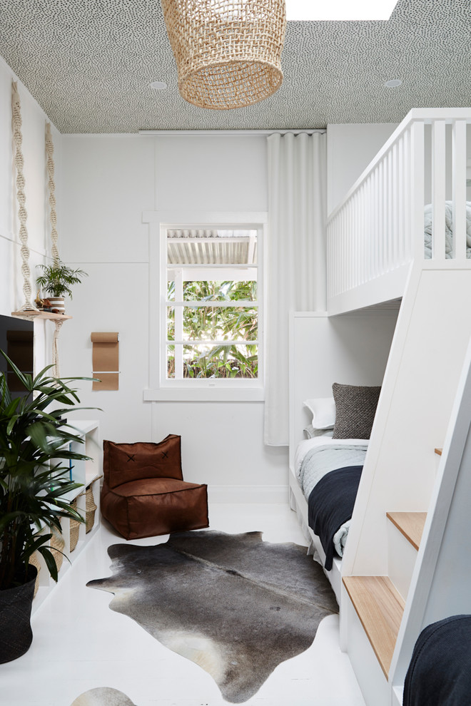 Inspiration for a mid-sized tropical gender-neutral kids' bedroom for kids 4-10 years old in Sydney with white walls, painted wood floors and white floor.