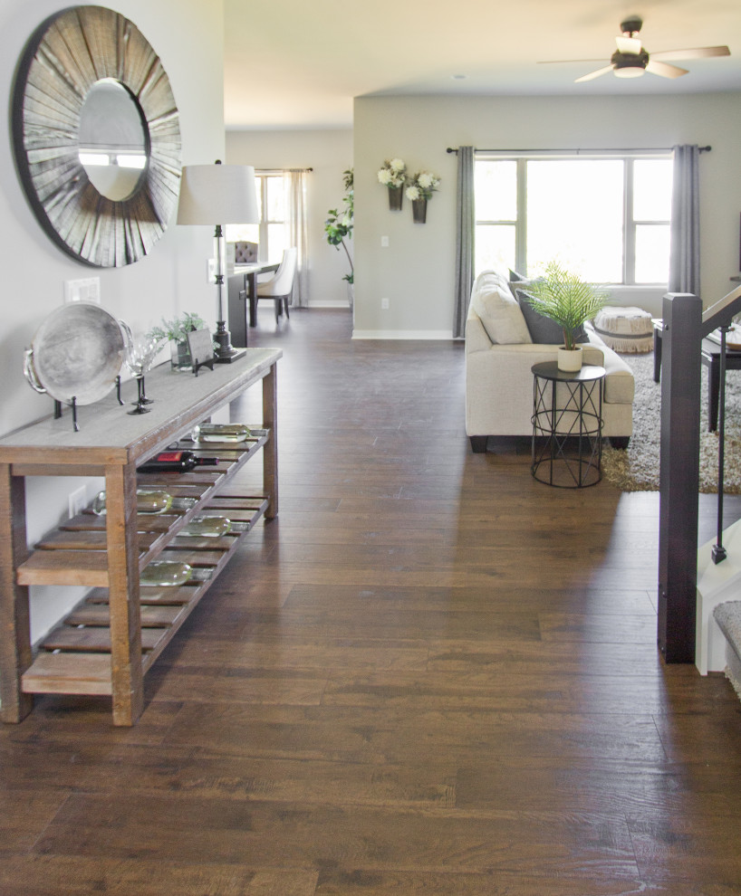 Example of a transitional laminate floor and brown floor entryway design