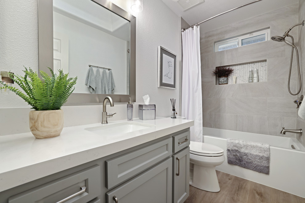 Inspiration for a modern kids bathroom in Sacramento with shaker cabinets, grey cabinets, an alcove tub, a shower/bathtub combo, vinyl floors, an undermount sink, engineered quartz benchtops, brown floor, a shower curtain, white benchtops, a single vanity and a built-in vanity.