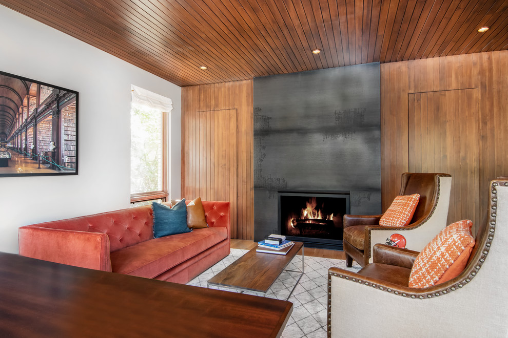 Photo of a midcentury formal living room in Denver with white walls, medium hardwood floors and a standard fireplace.