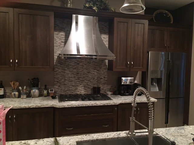 Inspiration for a mid-sized transitional l-shaped limestone floor and beige floor open concept kitchen remodel with an undermount sink, shaker cabinets, dark wood cabinets, granite countertops, multicolored backsplash, matchstick tile backsplash, stainless steel appliances and an island