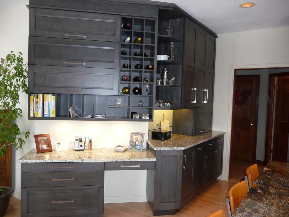 Large transitional u-shaped light wood floor eat-in kitchen photo in Milwaukee with an undermount sink, flat-panel cabinets, gray cabinets, granite countertops, white backsplash, porcelain backsplash, stainless steel appliances and an island