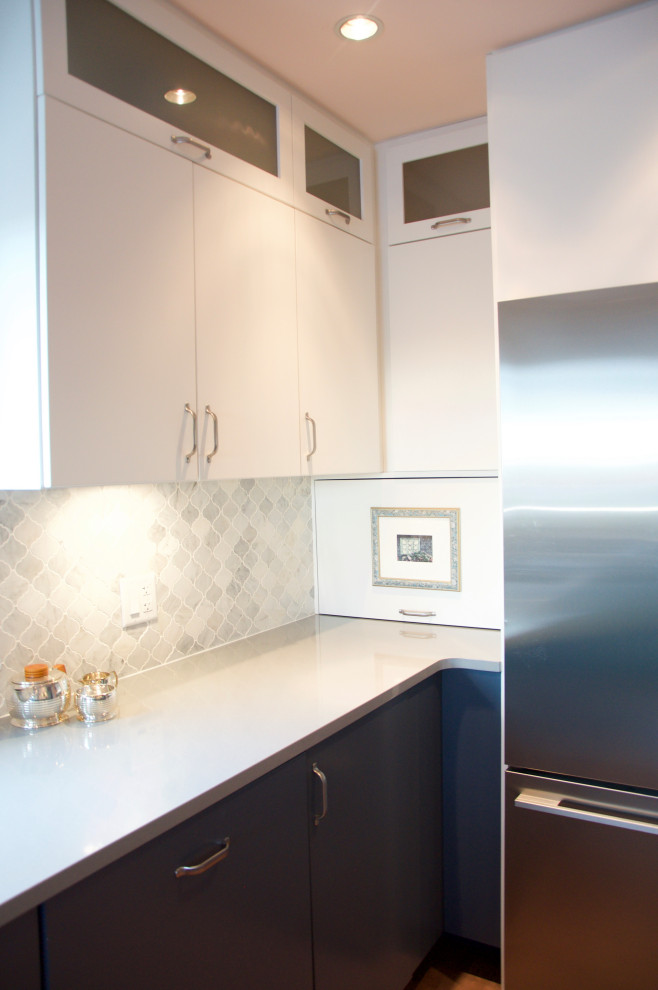 This is an example of a mid-sized eclectic l-shaped eat-in kitchen in Vancouver with an undermount sink, flat-panel cabinets, blue cabinets, copper benchtops, grey splashback, marble splashback, medium hardwood floors, a peninsula and brown floor.
