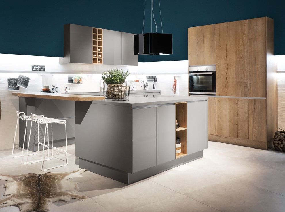 Design ideas for a mid-sized contemporary u-shaped open plan kitchen in Hanover with flat-panel cabinets, white splashback, black appliances, grey benchtop, grey cabinets, wood benchtops and with island.