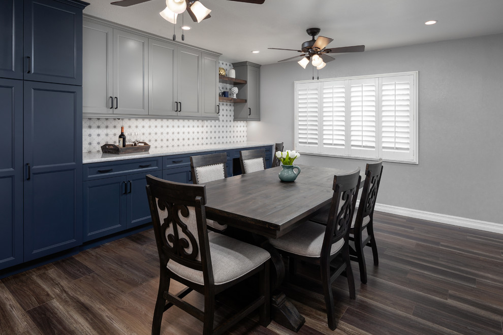 Kitchen/dining room combo - mid-sized rustic vinyl floor and brown floor kitchen/dining room combo idea in Orange County with gray walls