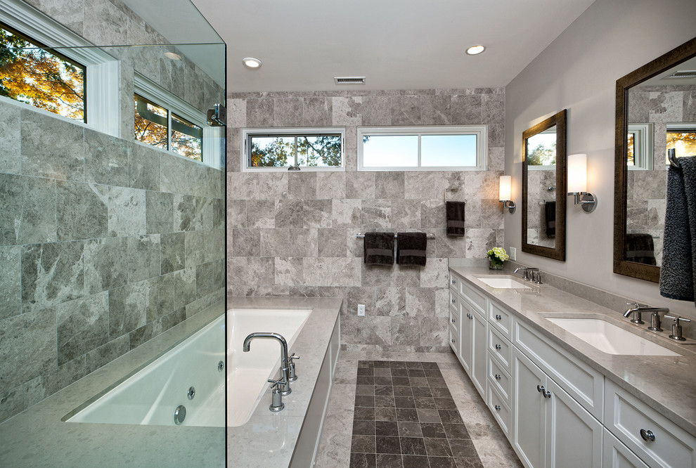 This is an example of a transitional bathroom in Richmond with recessed-panel cabinets, white cabinets, an undermount tub and gray tile.