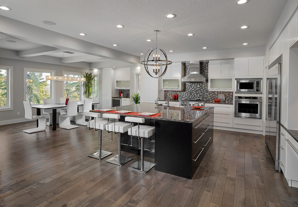 Example of a mid-sized transitional dark wood floor kitchen design in Edmonton with a farmhouse sink, flat-panel cabinets, white cabinets, quartzite countertops, black backsplash, mosaic tile backsplash, stainless steel appliances and an island