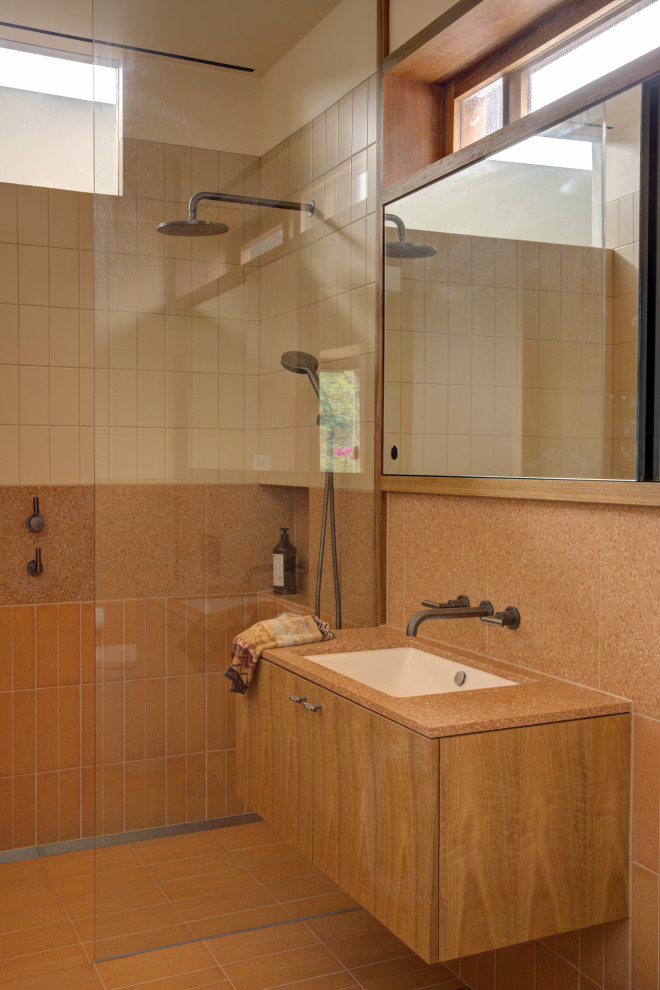 Photo of a midcentury bathroom in Sydney with flat-panel cabinets, medium wood cabinets, an alcove shower, orange tile, white walls, an undermount sink, orange floor, an open shower, orange benchtops, a niche, a single vanity and a floating vanity.
