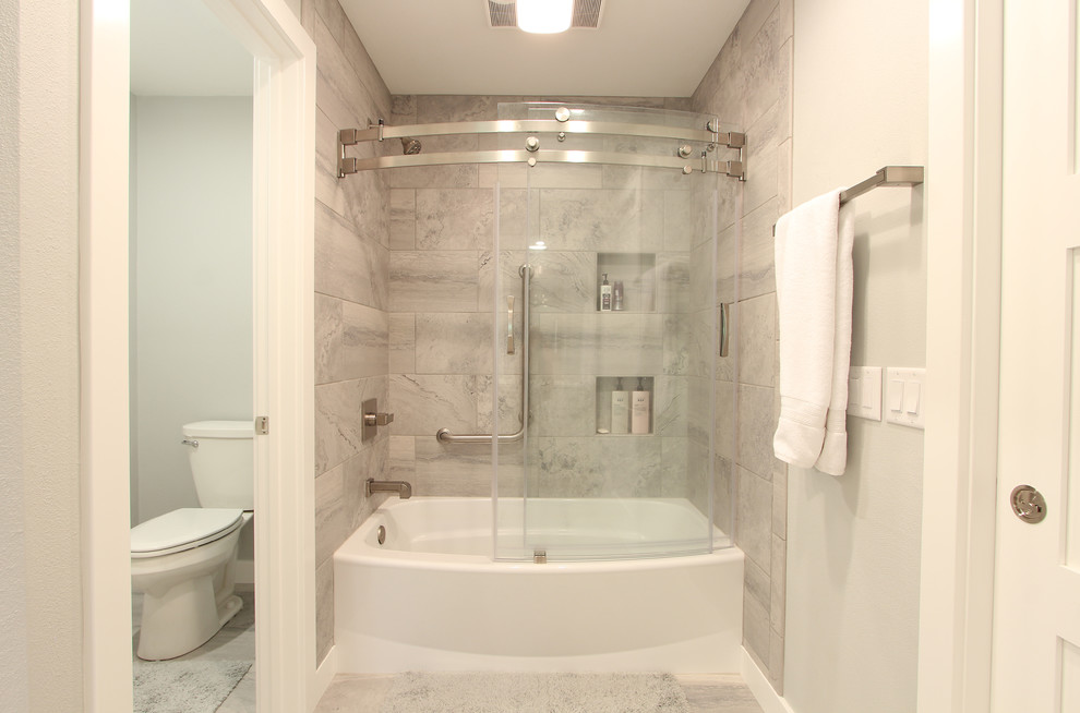 Inspiration for a mid-sized transitional master gray tile and marble tile marble floor and white floor bathroom remodel in Other with shaker cabinets, white cabinets, a two-piece toilet, gray walls, an undermount sink and quartz countertops