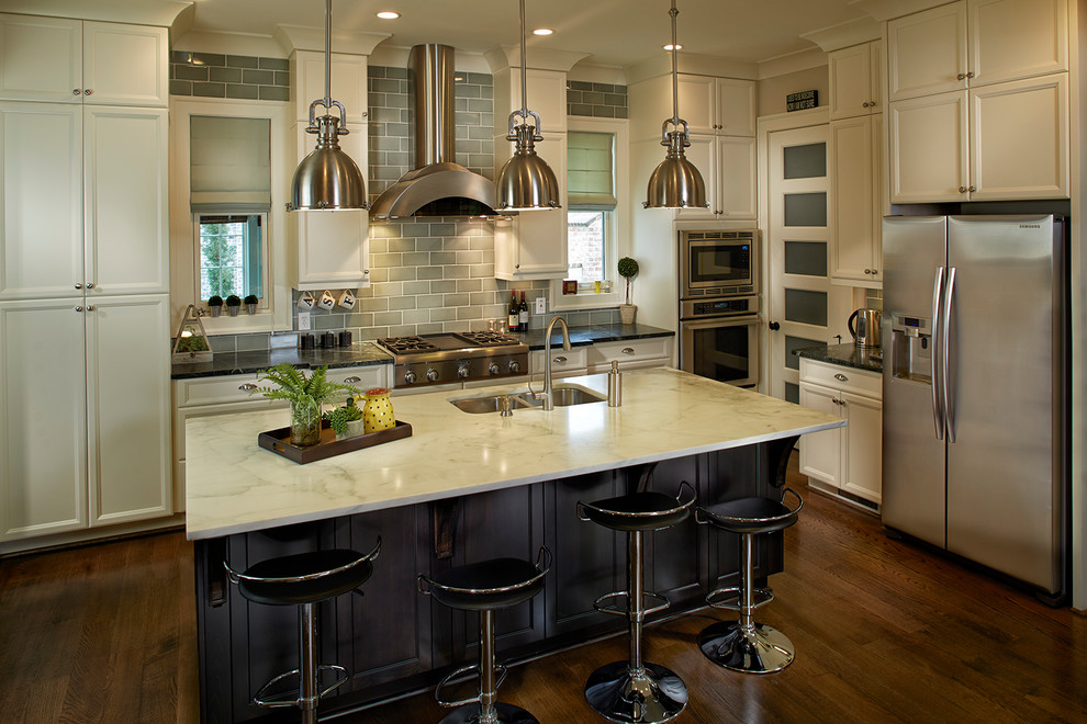 Open concept kitchen - large transitional l-shaped dark wood floor open concept kitchen idea with a double-bowl sink, recessed-panel cabinets, gray backsplash, ceramic backsplash, stainless steel appliances, an island and white cabinets