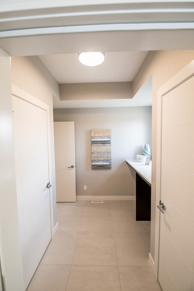 Design ideas for a contemporary laundry room in Calgary with grey walls, ceramic floors, flat-panel cabinets, dark wood cabinets, laminate benchtops, a side-by-side washer and dryer and white floor.