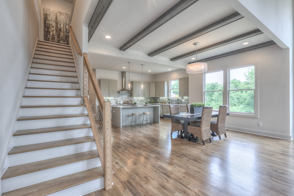 Inspiration for a mid-sized transitional medium tone wood floor great room remodel in Nashville with white walls
