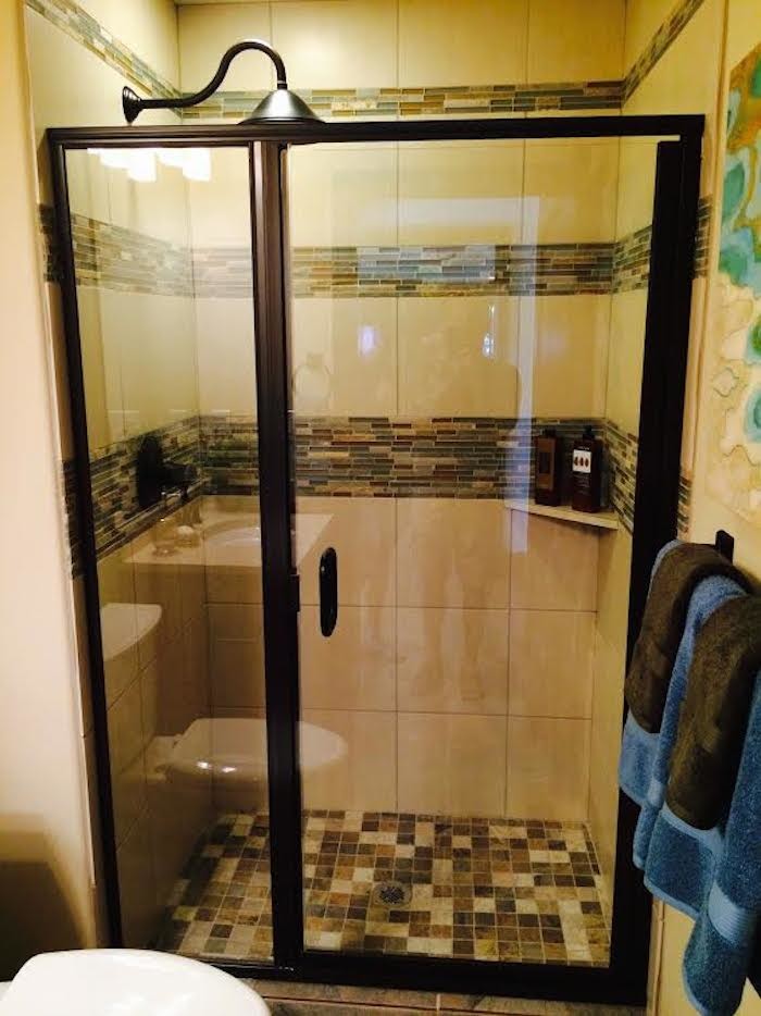 Example of a mid-sized transitional 3/4 alcove shower design in Denver with beige walls and a hinged shower door