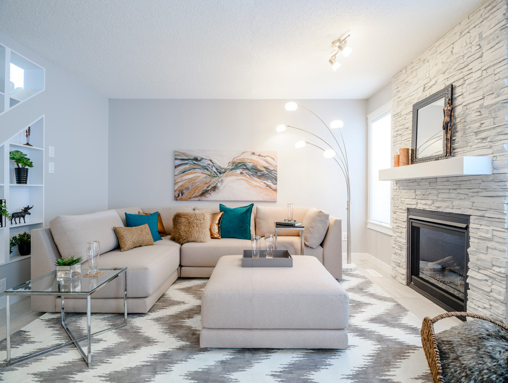 This is an example of a transitional formal living room in Edmonton with white walls, a standard fireplace, a stone fireplace surround and no tv.