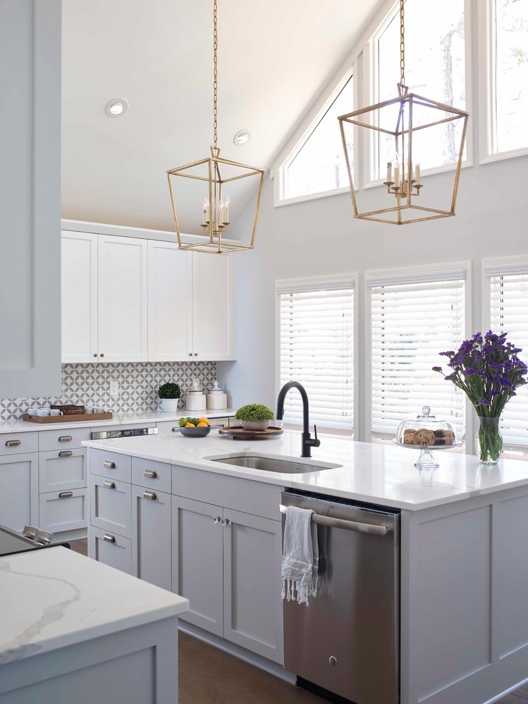 Design ideas for a transitional l-shaped kitchen in Raleigh with an undermount sink, shaker cabinets, grey cabinets, stainless steel appliances, with island and white benchtop.