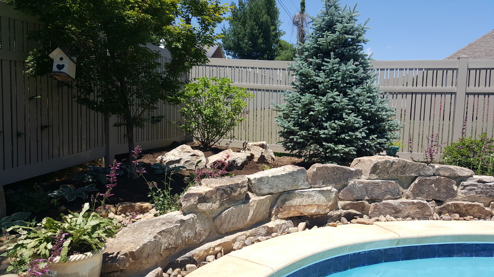 Mid-sized transitional backyard custom-shaped lap pool in Huntington with decking.