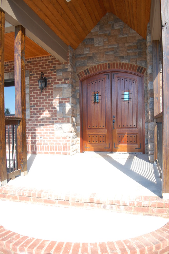 Example of a mountain style brown three-story brick exterior home design