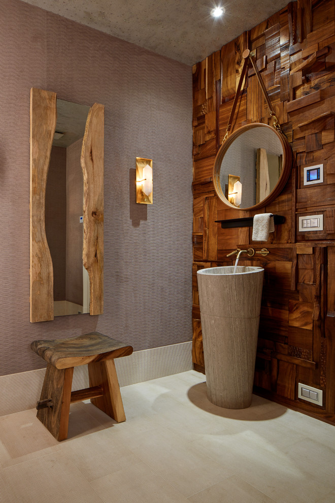 Design ideas for a contemporary powder room in New York with brown walls, a pedestal sink and beige floor.