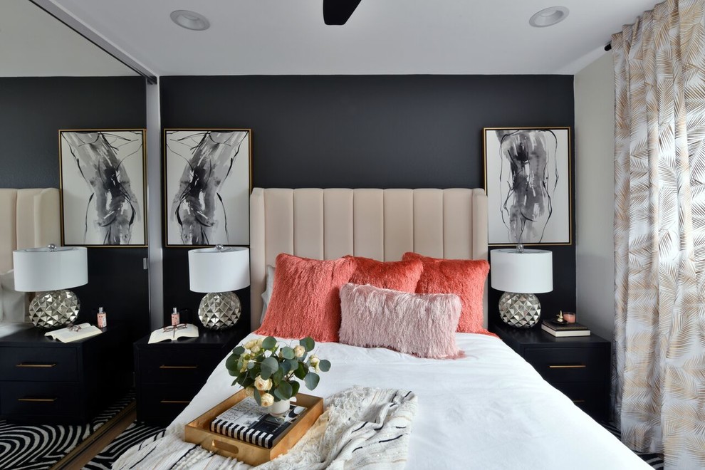 This is an example of a contemporary bedroom in San Diego with black walls, no fireplace, medium hardwood floors and brown floor.