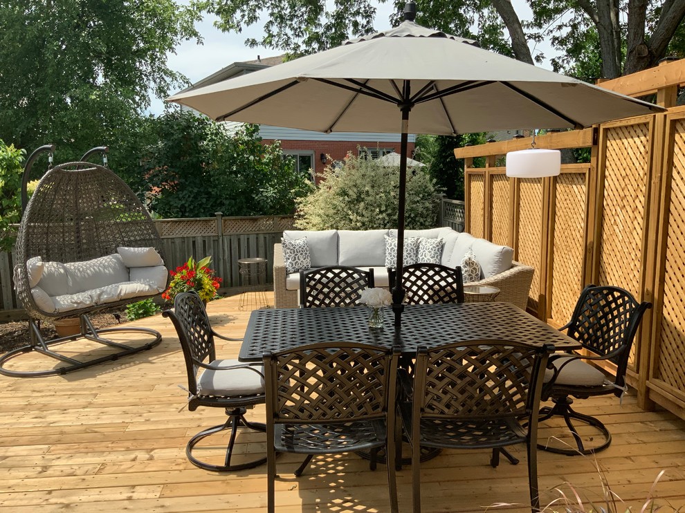 Mid-sized transitional backyard deck photo in Toronto with a fire pit and no cover
