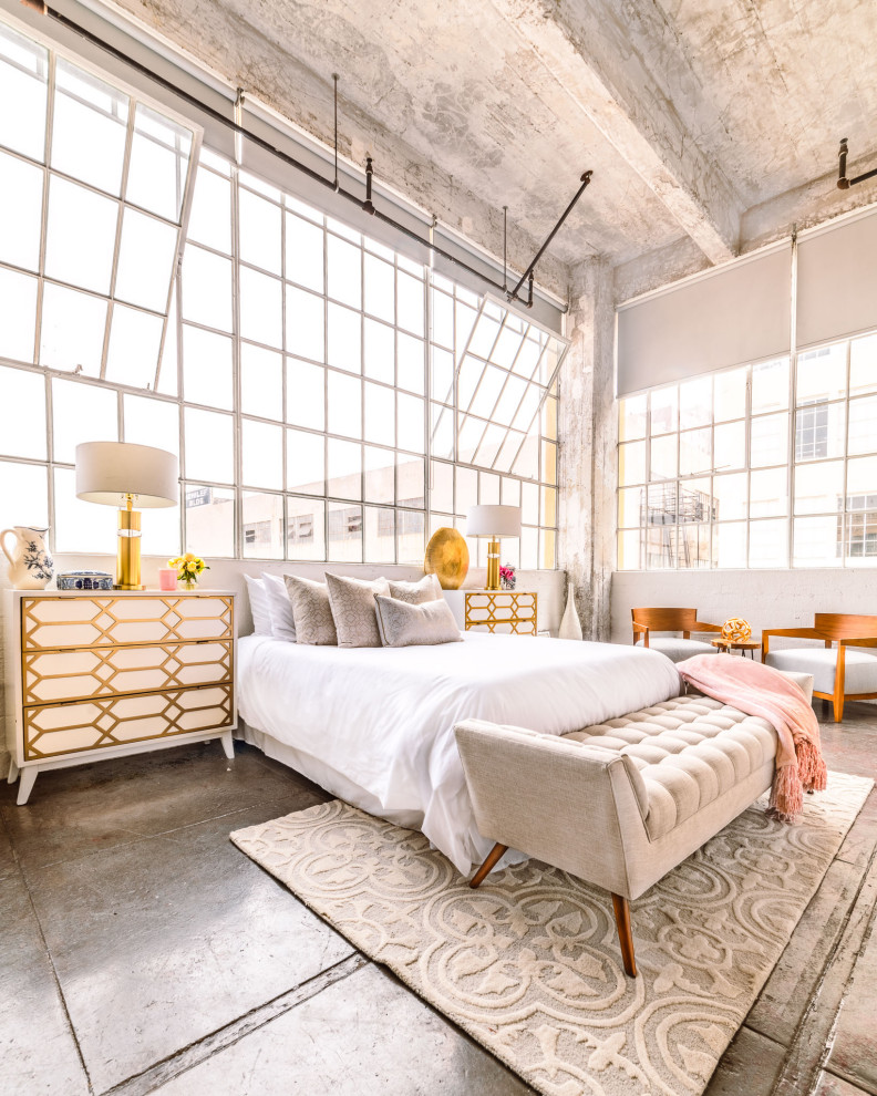 Mid-sized industrial master bedroom in Chicago with grey walls, concrete floors, no fireplace, grey floor, coffered and brick walls.