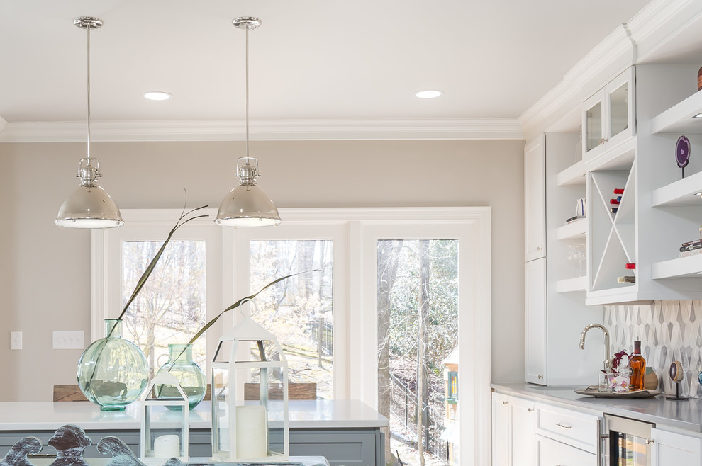Open concept kitchen - huge transitional galley medium tone wood floor open concept kitchen idea in Raleigh with a farmhouse sink, flat-panel cabinets, white cabinets, quartz countertops, gray backsplash, ceramic backsplash, stainless steel appliances and two islands