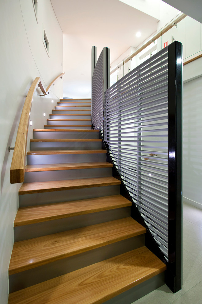 Inspiration for a large contemporary wood curved staircase in Brisbane with wood railing.