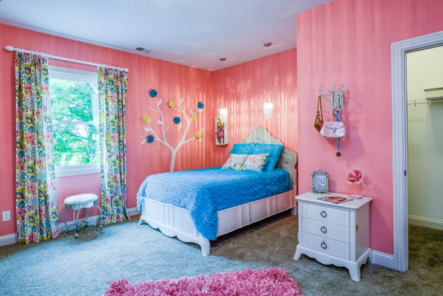 This is an example of a mid-sized transitional kids' room for girls in Louisville with blue walls and carpet.