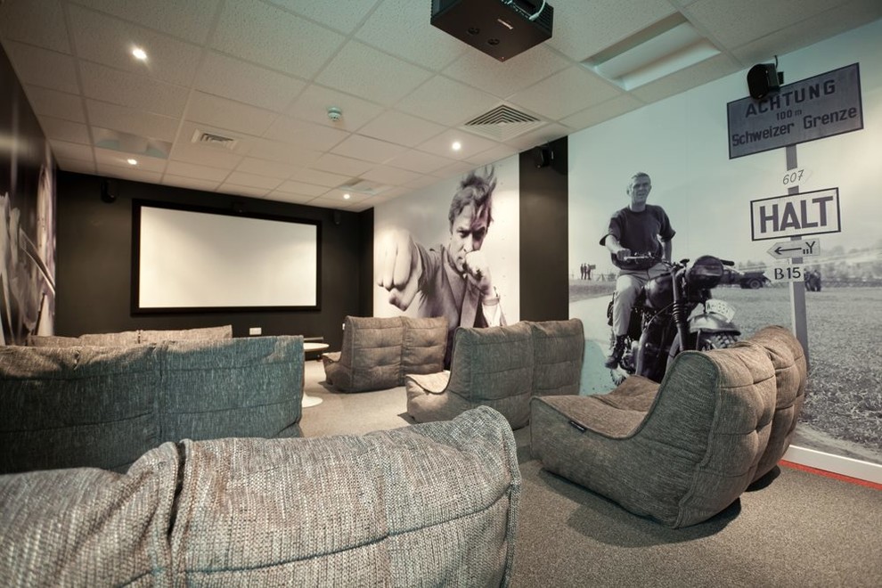 Design ideas for a contemporary home theatre in London with grey floor.