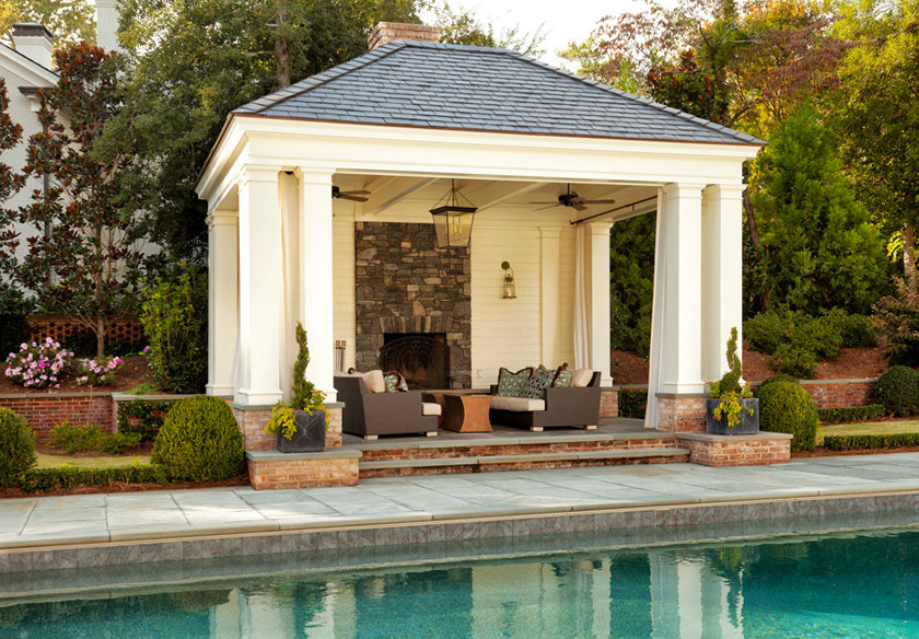 Backyard custom-shaped pool house photo in Cincinnati