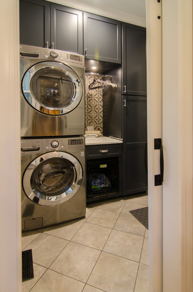 Inspiration for a small transitional single-wall dedicated laundry room in Raleigh with flat-panel cabinets, dark wood cabinets, quartz benchtops, porcelain floors, a stacked washer and dryer, brown floor and white benchtop.