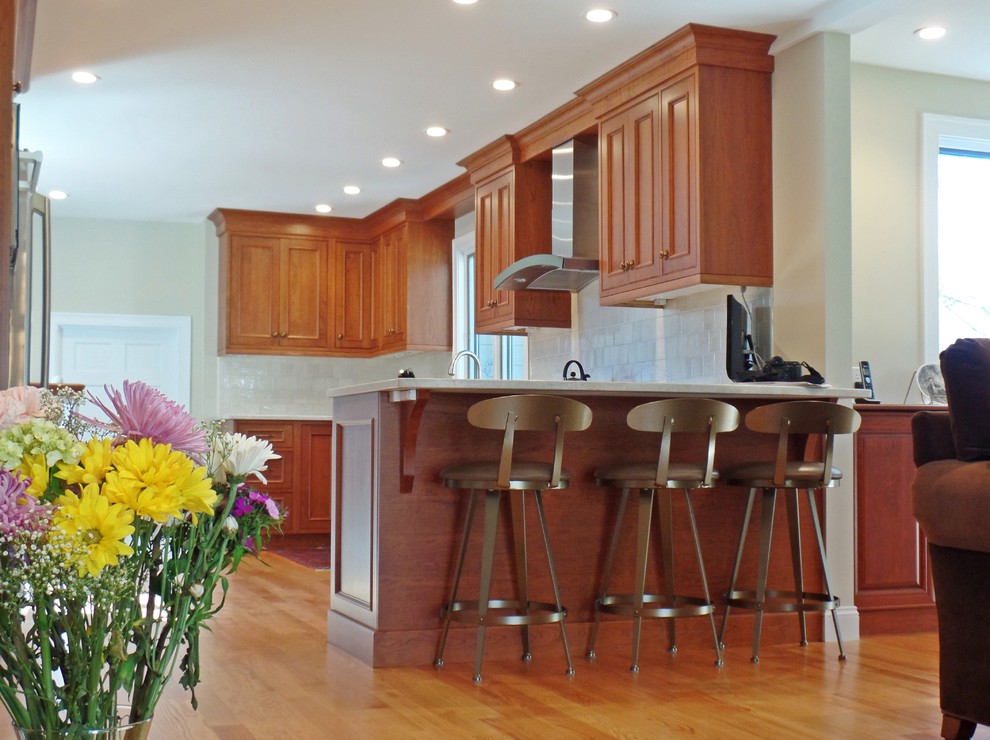 Example of a large transitional l-shaped light wood floor open concept kitchen design with a single-bowl sink, beaded inset cabinets, medium tone wood cabinets, quartzite countertops, white backsplash, ceramic backsplash, stainless steel appliances and no island
