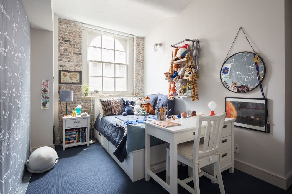 Inspiration for an industrial kids' bedroom for boys in New York with white walls, carpet and blue floor.