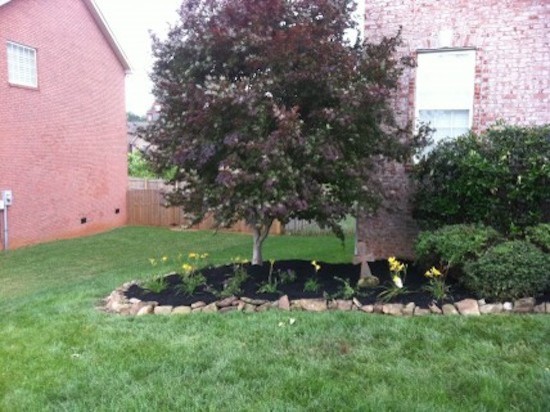 This is an example of a mid-sized transitional full sun front yard landscaping for spring.