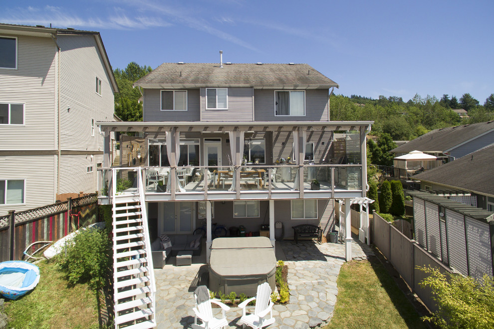Outdoor kitchen deck - large transitional backyard outdoor kitchen deck idea in Vancouver with a pergola