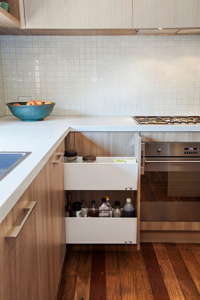 Photo of a mid-sized scandinavian u-shaped eat-in kitchen in Sydney with light wood cabinets, white splashback, mosaic tile splashback, stainless steel appliances and with island.