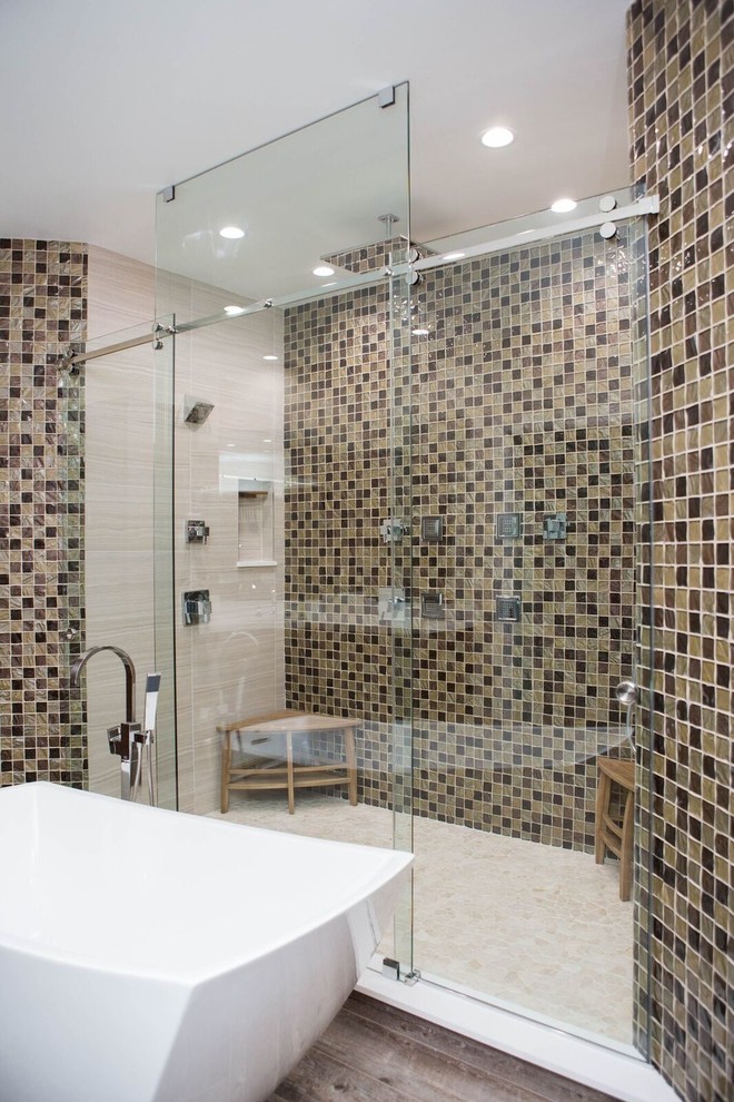 Large contemporary master bathroom in Miami with a freestanding tub, an alcove shower, a two-piece toilet, beige tile, brown tile, mosaic tile, beige walls and dark hardwood floors.
