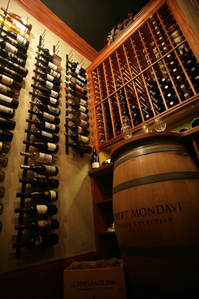 Design ideas for a small mediterranean wine cellar in Other with medium hardwood floors, storage racks and brown floor.
