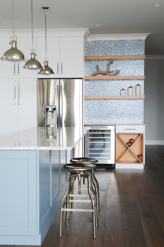 Inspiration for a large transitional u-shaped medium tone wood floor open concept kitchen remodel in Vancouver with shaker cabinets, white cabinets, quartz countertops, metallic backsplash, glass tile backsplash and stainless steel appliances