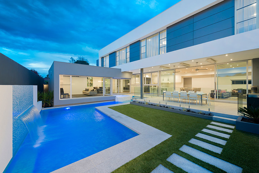 Photo of a mid-sized contemporary backyard l-shaped pool in Melbourne with a hot tub.