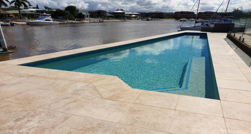 Inspiration for a large modern backyard custom-shaped natural pool in Sunshine Coast.