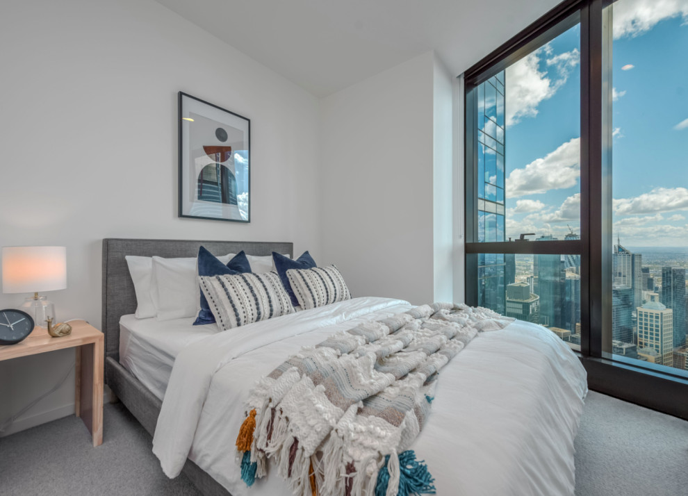Small contemporary guest bedroom in Melbourne with white walls, carpet and grey floors.