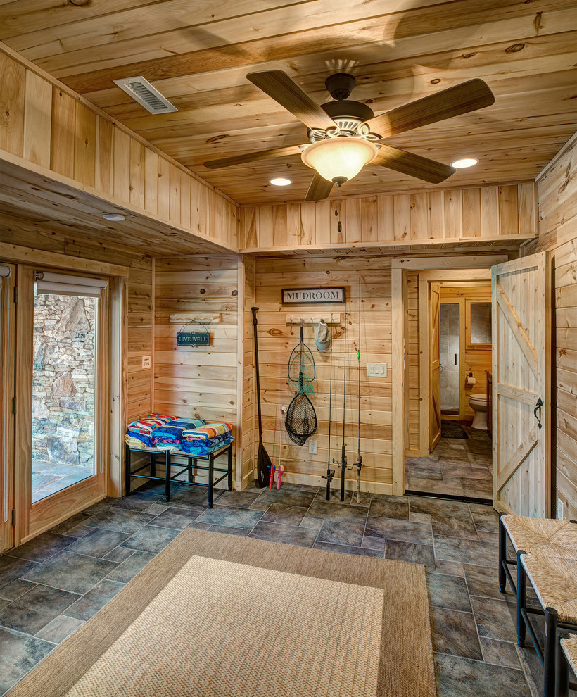 Design ideas for a mid-sized country mudroom in Charlotte with a double front door and a light wood front door.
