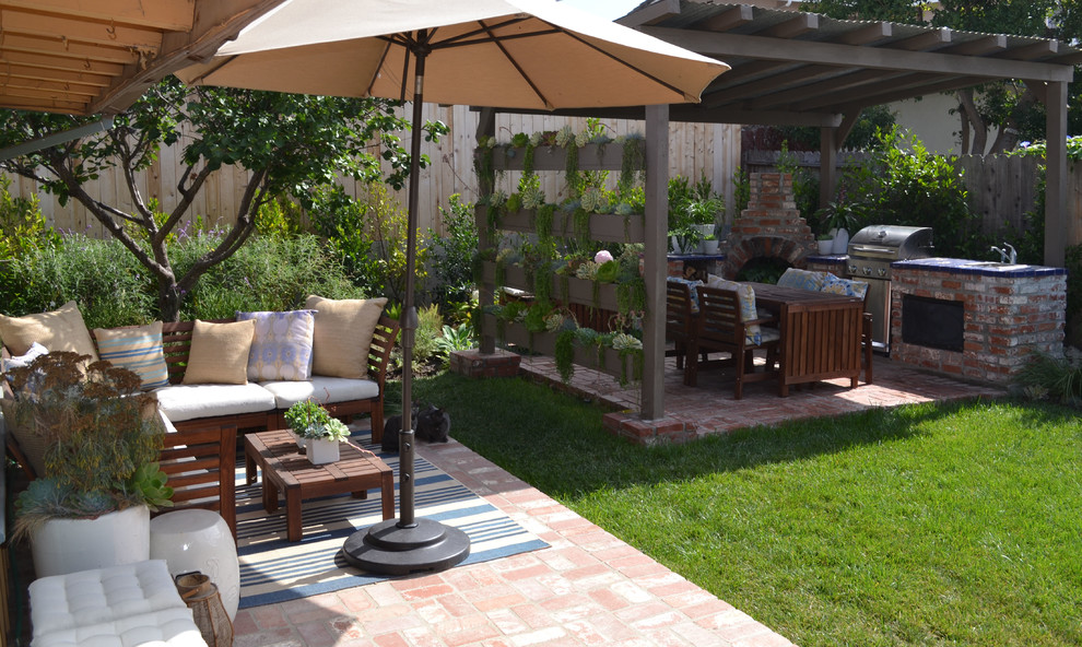 Photo of a small contemporary backyard garden in Orange County with brick pavers.