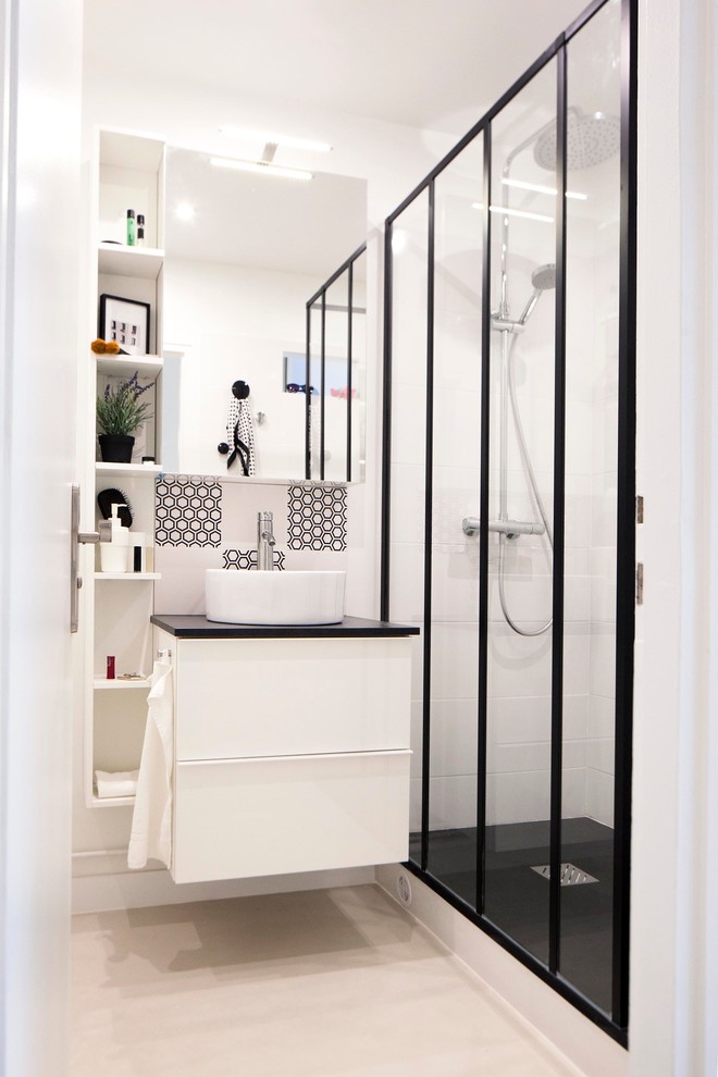 Mid-sized contemporary 3/4 bathroom in Paris with white cabinets, an alcove shower, white tile, black tile, white walls and a vessel sink.