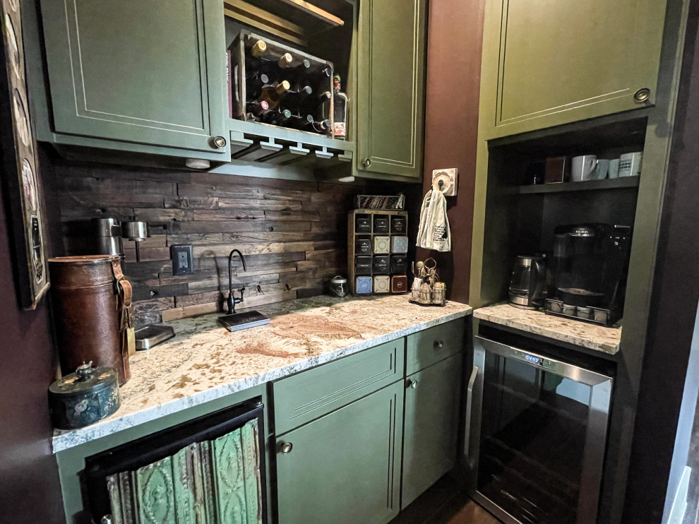This is an example of a mid-sized country u-shaped home bar with no sink, recessed-panel cabinets, green cabinets, marble benchtops, brown splashback, timber splashback, bamboo floors, brown floor and multi-coloured benchtop.