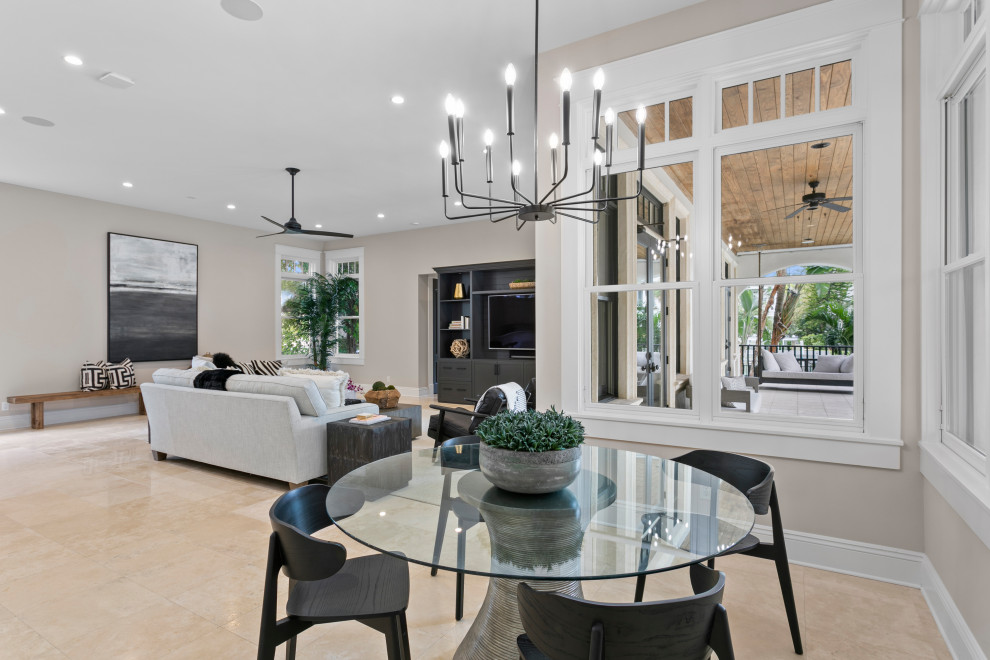 Mid-sized contemporary open plan dining in Tampa with beige walls, marble floors and no fireplace.