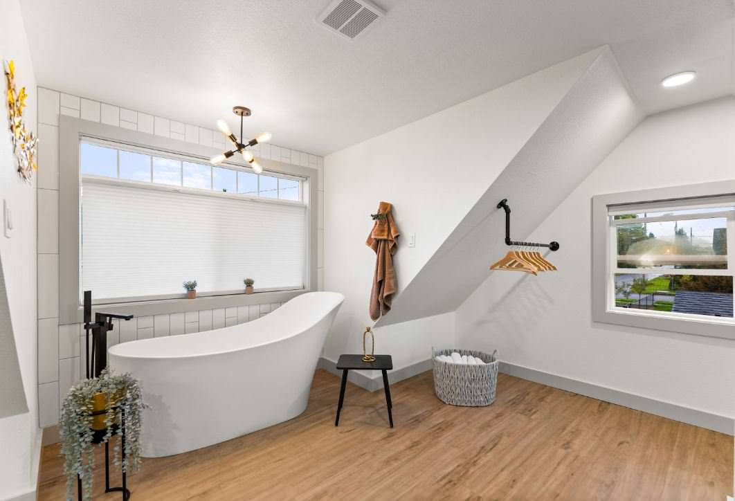 freestanding tub upstairs in master bedroom/bathroom with toilet room isolated on other side of the room.