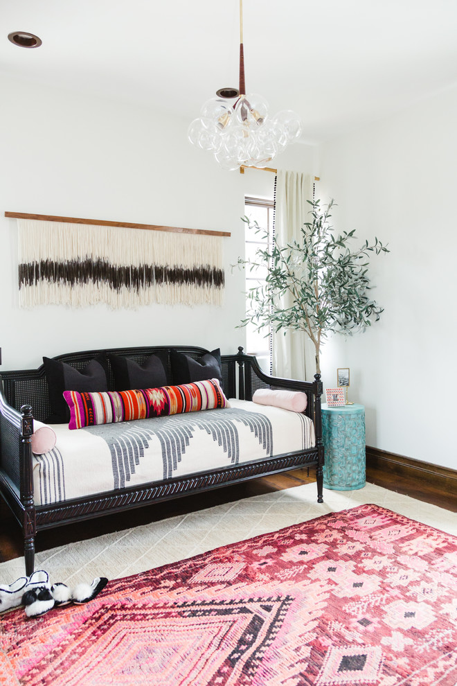 Inspiration for a large eclectic guest bedroom in San Diego with white walls, dark hardwood floors, no fireplace and brown floor.