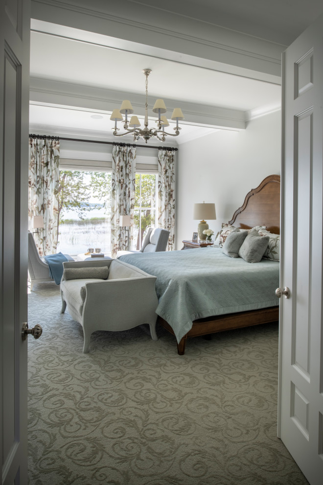 This is an example of a large beach style master bedroom in Minneapolis with grey walls, carpet and green floor.